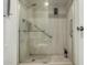This accessible shower features grab bars, a shower head, and a stone look at 7625 E Camelback Rd # B124, Scottsdale, AZ 85251