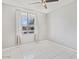 Bright bedroom showcasing a window with curtains, tile floors and neutral paint at 7720 W Indianola Ave, Phoenix, AZ 85033