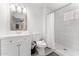 Modern bathroom featuring a shower with white tile, toilet, vanity, and a grey accent rug at 8044 N 10Th Pl, Phoenix, AZ 85020