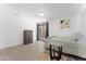 Bright bedroom with wood-look floors, and a glass door leading to the backyard at 8044 N 10Th Pl, Phoenix, AZ 85020