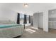 Bedroom featuring a window, tile flooring, closet, and doorway to the laundry room at 8044 N 10Th Pl, Phoenix, AZ 85020