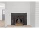 Close up shot of fireplace in living area next to doorway to dining area at 8044 N 10Th Pl, Phoenix, AZ 85020