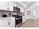Modern kitchen featuring white cabinets, stainless steel appliances, and gray subway tile backsplash at 8044 N 10Th Pl, Phoenix, AZ 85020