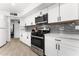 Modern kitchen featuring white cabinets, stainless steel appliances, and gray subway tile backsplash at 8044 N 10Th Pl, Phoenix, AZ 85020