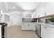 Bright kitchen with stainless steel appliances, white cabinets and gray backsplash at 8044 N 10Th Pl, Phoenix, AZ 85020
