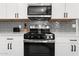 Modern kitchen featuring white cabinets, stainless steel appliances, and gray subway tile backsplash at 8044 N 10Th Pl, Phoenix, AZ 85020