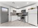 Contemporary kitchen featuring white cabinetry, stainless steel appliances, and a gray subway tile backsplash at 8044 N 10Th Pl, Phoenix, AZ 85020