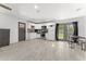 A full kitchen featuring all-white cabinetry and modern appliances, with an adjoining living area at 8044 N 10Th Pl, Phoenix, AZ 85020