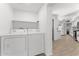 Laundry room features modern washer and dryer with overhead storage shelf at 8044 N 10Th Pl, Phoenix, AZ 85020
