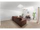 Spacious living room featuring tile floors, ample seating, and a bright skylight at 8044 N 10Th Pl, Phoenix, AZ 85020