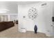 Stylish living room with a white accent wall and tiled floors extending into dining and living areas at 8044 N 10Th Pl, Phoenix, AZ 85020