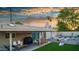 Outdoor living space featuring a covered patio, dining set, and artificial turf, perfect for entertaining at 8338 E Monterosa St, Scottsdale, AZ 85251