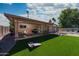 Spacious backyard with artificial turf, paver patio, built-in grill, and lounge chairs perfect for relaxing at 8338 E Monterosa St, Scottsdale, AZ 85251