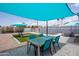 Covered patio with a dining area, lounge chairs, and a pool, perfect for outdoor entertaining at 8444 E Piccadilly Rd, Scottsdale, AZ 85251