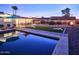 This resort-style backyard boasts a pool, outdoor seating, lounge chairs, a fire pit, and beautiful desert landscaping at 8444 E Piccadilly Rd, Scottsdale, AZ 85251