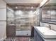 This beautifully renovated bathroom boasts a large glass shower, decorative tile, and a custom sink at 8444 E Piccadilly Rd, Scottsdale, AZ 85251