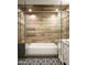 This renovated bathroom boasts a glass shower and tub combination, custom sink, and decorative black and white tile at 8444 E Piccadilly Rd, Scottsdale, AZ 85251