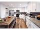 Bright kitchen with stainless steel appliances, granite countertops and a rustic wood island with seating at 8444 E Piccadilly Rd, Scottsdale, AZ 85251