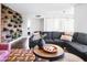 Comfortable living room features a sectional sofa, modern coffee table, and a plant wall at 8444 E Piccadilly Rd, Scottsdale, AZ 85251