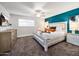 This primary bedroom boasts a rustic whitewashed bed frame and a large window for plenty of natural light at 8444 E Piccadilly Rd, Scottsdale, AZ 85251