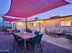 Enjoy evening dinners on this covered outdoor patio with a large dining table and adjacent seating area at 8444 E Piccadilly Rd, Scottsdale, AZ 85251