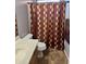 Functional bathroom with a patterned shower curtain, toilet, and sink with vanity at 9108 W Kirby Ave, Tolleson, AZ 85353