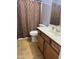 Bathroom showcasing a vanity with sink, toilet, and a shower with a stylish curtain at 9108 W Kirby Ave, Tolleson, AZ 85353