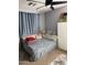 Bedroom featuring a comfy bed, ceiling fan, and soft, light-blocking curtains at 9108 W Kirby Ave, Tolleson, AZ 85353