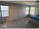 A spacious carpeted bedroom with natural light and a ceiling fan provides a relaxing space at 9108 W Kirby Ave, Tolleson, AZ 85353