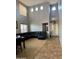 Bright and airy living room with soaring ceilings, complemented by a black leather sofa at 9108 W Kirby Ave, Tolleson, AZ 85353