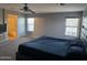 Carpeted bedroom with natural light showing an en-suite bathroom and offering a comfortable private retreat at 9108 W Kirby Ave, Tolleson, AZ 85353