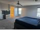 Large main bedroom featuring a TV, bed, and a view into the en-suite bathroom at 9108 W Kirby Ave, Tolleson, AZ 85353