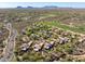 Expansive aerial view of luxury homes on a golf course, showcasing the scenic mountain backdrop at 9998 E Taos Dr, Scottsdale, AZ 85262