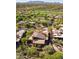 Aerial view of tan home with tile roof and desert landscaping, blending seamlessly into the serene golf course community at 9998 E Taos Dr, Scottsdale, AZ 85262