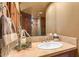 Bright bathroom with a tile countertop vanity, large mirror, and ample lighting at 9998 E Taos Dr, Scottsdale, AZ 85262