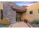 Close-up view of the front door featuring desert plants and stone accents at 9998 E Taos Dr, Scottsdale, AZ 85262