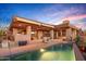 Beautiful home featuring a pool, outdoor seating, and desert landscaping, perfect for outdoor living and entertaining at 9998 E Taos Dr, Scottsdale, AZ 85262