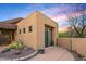 Desert home with a neutral palette, well-maintained yard, and artistic desert landscaping at 9998 E Taos Dr, Scottsdale, AZ 85262
