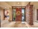 Inviting front entrance features a wooden door with glass sidelights and a view to a bedroom at 9998 E Taos Dr, Scottsdale, AZ 85262