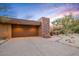 Beautiful home with a garage and desert landscaping at sunset at 9998 E Taos Dr, Scottsdale, AZ 85262