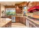 Well-equipped kitchen with granite countertops, gas range, stainless appliances, and scenic outdoor views at 9998 E Taos Dr, Scottsdale, AZ 85262