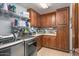 Laundry room with stainless steel washer and dryer, brown cabinets, and ample storage space at 9998 E Taos Dr, Scottsdale, AZ 85262