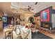 Open living room with hardwood floors, clerestory windows, stone fireplace, and access to an outdoor space at 9998 E Taos Dr, Scottsdale, AZ 85262
