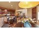 View of the open-plan living room and dining area with dark wood cabinets and granite countertops at 9998 E Taos Dr, Scottsdale, AZ 85262
