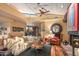 Comfortable living room showcases a stone fireplace, hardwood floors, wood ceiling, and clerestory windows at 9998 E Taos Dr, Scottsdale, AZ 85262
