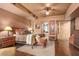 A main bedroom with hardwood floors, a king-size bed, and an attached bathroom at 9998 E Taos Dr, Scottsdale, AZ 85262