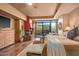 The spacious main bedroom features a fireplace, access to a patio, and natural lighting at 9998 E Taos Dr, Scottsdale, AZ 85262