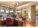 Office featuring a desk, large windows, and views of the beautiful landscaping at 9998 E Taos Dr, Scottsdale, AZ 85262