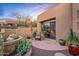 Inviting outdoor patio area with comfortable seating, desert plants, and seamless access to indoor living at 9998 E Taos Dr, Scottsdale, AZ 85262