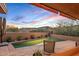 Inviting pool surrounded by desert landscape, offering a serene outdoor retreat with beautiful Arizona sky at 9998 E Taos Dr, Scottsdale, AZ 85262